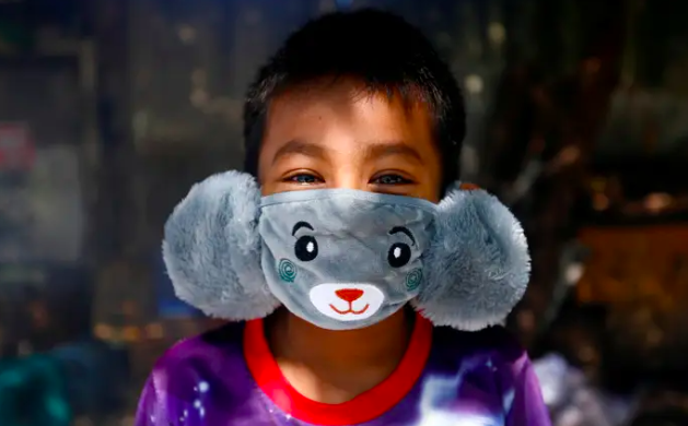 child wearing a face mask made from grey teddy bear